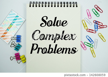 Solve Complex Problems text message written on notepad with stationery flat lay on white background Solve Complex Problems text message written on notepad with stationery flat lay on white background 142608059
