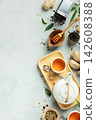 Natural Tea and Wellness Flat Lay with Herbs, Honey, and Ginger 142608388