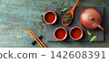 Traditional Asian Tea Ceremony with Red Clay Teapot and Loose Leaf Tea on Rustic Surface 142608391