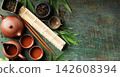 Japanese Tea Ceremony Elements with Teaware and Bamboo Mat on Rustic Background 142608394