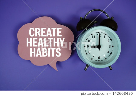 Create Healthy Habits text on speech bubble with alarm clock on purple background 142608450