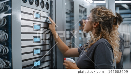 Female IT Specialist Cleaning Server Rack LCD Diagnostic Displays Female IT Specialist Cleaning Server Rack LCD Diagnostic Displays 142608499