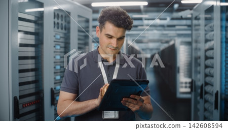 IT Specialist Using Digital Tablet in Data Center Server Room 142608594
