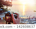 Photographer takes photos of beautiful sunset 142608637