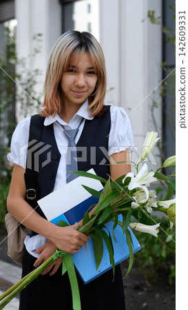 Teenage Schoolgirl with Notebooks and Flowers on September 1, Back to School Preparation, Knowledge Day, School Supplies and High School Education Teenage Schoolgirl with Notebooks and Flowers on September 1, Back to School Preparation, Knowledge Day, School Supplies and High School Education 142609331