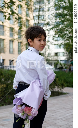 Schoolboy with Large Flower Bouquet on September 1, First Day of School, Knowledge Day, Flowers for Teacher and New School Year Celebration Schoolboy with Large Flower Bouquet on September 1, First Day of School, Knowledge Day, Flowers for Teacher and New School Year Celebration 142609339