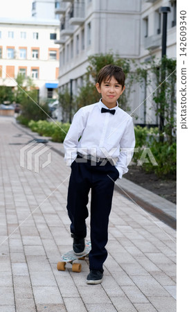 Modern Schoolboy with Skateboard on September 1, Back to School, First Day of Classes, Student Lifestyle, Childhood Hobbies and School Fashion Modern Schoolboy with Skateboard on September 1, Back to School, First Day of Classes, Student Lifestyle, Childhood Hobbies and School Fashion 142609340