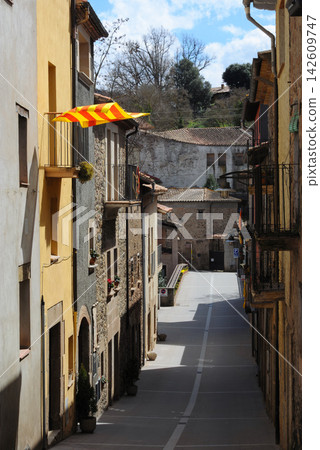 Catalan flag waving in old European town street Catalan flag waving in old European town street 142609747