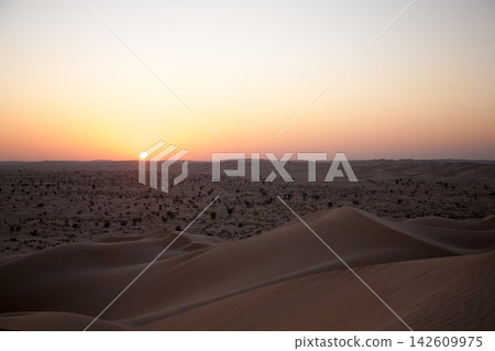 Sunset over sand dunes of the Rub al-Khali desert in Dhofar, Oman Sunset over sand dunes of the Rub al-Khali desert in Dhofar, Oman 142609975