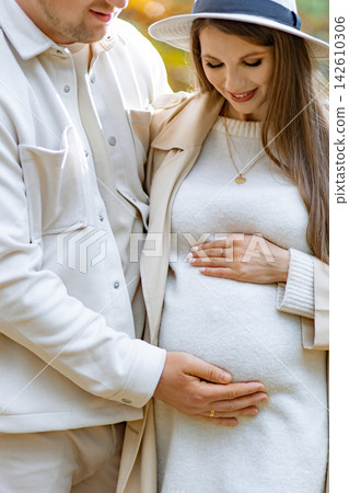 A loving couple embraces, the woman cradling her baby bump with tenderness and joy A loving couple embraces, the woman cradling her baby bump with tenderness and joy 142610306