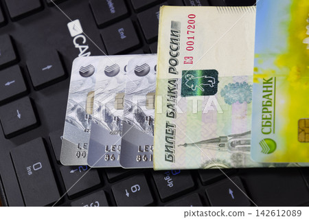 Credit card lying on black computer keyboard Credit card lying on black computer keyboard 142612089