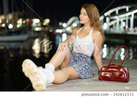 Evening portrait of girl against background of port in Vell in Barcelona. Yachts and boats Evening portrait of girl against background of port in Vell in Barcelona. Yachts and boats 142612151