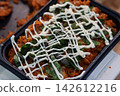 Spicy Pasta Dish with Creamy Drizzle and Fresh Herbs 142612216