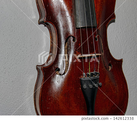 Vintage Violin Body with F Holes Bridge and Strings Close Up Vintage Violin Body with F Holes Bridge and Strings Close Up 142612338