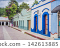 Colorful colonial street showing traditional buildings and mountain town atmosphere in San Cristobal de las Casas Chiapas Mexico with painted facades cobblestone historic center Mexican. 142613885