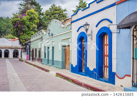 Colorful colonial street showing traditional buildings and mountain town atmosphere in San Cristobal de las Casas Chiapas Mexico with painted facades cobblestone historic center Mexican. Colorful colonial street showing traditional buildings and mountain town atmosphere in San Cristobal de las Casas Chiapas Mexico with painted facades cobblestone historic center Mexican. 142613885