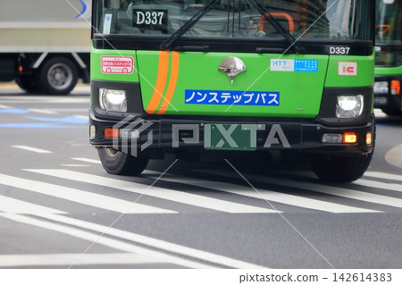 Image of a route bus turning left at an intersection. Image of a route bus turning left at an intersection. 142614383