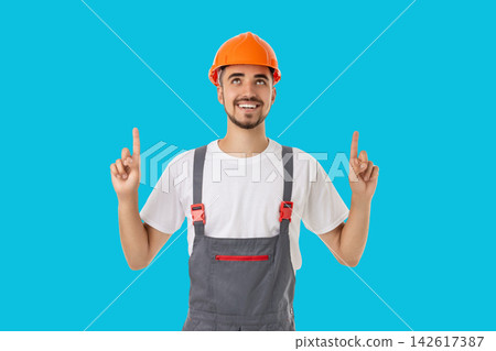Occupation, Builder positively gestures on blue background Occupation, Builder positively gestures on blue background 142617387