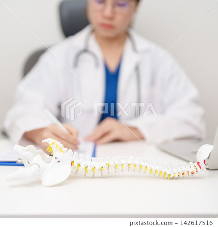 Doctor with human Spine anatomy model. Spinal Cord Disorder and disease, Back pain, Lumbar, Sacral pelvis, Cervical neck, Thoracic, Coccyx, Orthopedist, chiropractic, Office Syndrome and health Doctor with human Spine anatomy model. Spinal Cord Disorder and disease, Back pain, Lumbar, Sacral pelvis, Cervical neck, Thoracic, Coccyx, Orthopedist, chiropractic, Office Syndrome and health 142617516