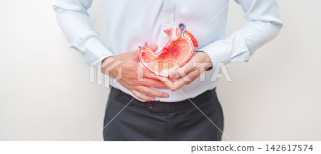 Man having abdomen pain or Stomachache with Gastric anatomy model. stomach diseases and ulcers, Gastroesophageal Reflux, November stomach cancer, Gastroenterologist consultation and Acid reflux 142617574