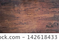 Surface of an old, weathered dark brown hardwood with a prominent linear grain pattern. The wood shows signs of aging, with fine superficial scratches, minor scuffs, cracks and a distressed finish 142618433
