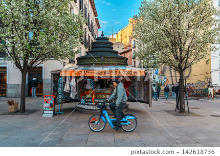 Ornate souvenir kiosk under blossoming trees on a Madrid city square Ornate souvenir kiosk under blossoming trees on a Madrid city square 142618736