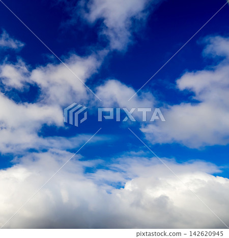 contrasting blue sky with fluffy white cloud mass at the lower part of the image framing contrasting blue sky with fluffy white cloud mass at the lower part of the image framing 142620945