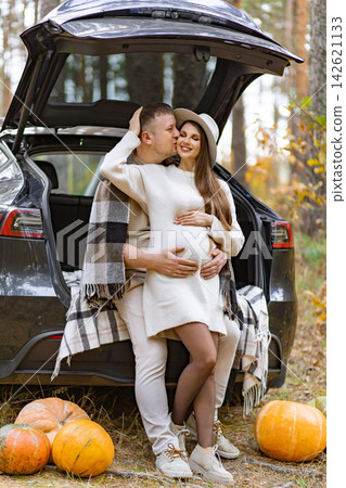 A loving couple enjoys a beautiful autumn day while expecting their first child A loving couple enjoys a beautiful autumn day while expecting their first child 142621133