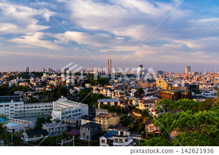 The Yokohama cityscape at dusk, with the Yokohama Landmark Tower visible in the distance. The Yokohama cityscape at dusk, with the Yokohama Landmark Tower visible in the distance. 142621936