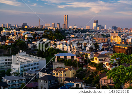 The Yokohama cityscape at dusk, with the Yokohama Landmark Tower visible in the distance. The Yokohama cityscape at dusk, with the Yokohama Landmark Tower visible in the distance. 142621938