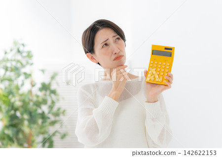Woman with calculator in trouble Woman with calculator in trouble 142622153
