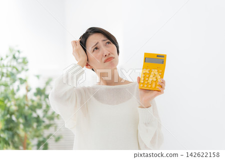 Woman with calculator in trouble Woman with calculator in trouble 142622158