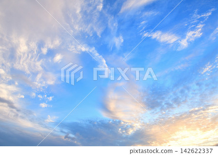 White clouds spread across a bright blue sky. White clouds spread across a bright blue sky. 142622337