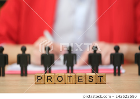 Voices united for change during a powerful protest with symbolic figures and signs Voices united for change during a powerful protest with symbolic figures and signs 142622680