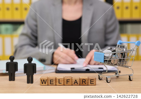 Welfare programs discussed in an office setting while planning support for communities Welfare programs discussed in an office setting while planning support for communities 142622728