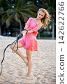 Woman in Pink Dress Outdoors 142622766