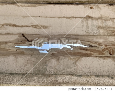 Moldy Wooden Wall with a Hole Revealing the Sky 142623225