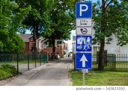 Road signs indicating parking options and nearby facilities in a city area 142623392