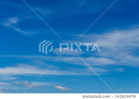 A vibrant ultramarine blue sky with thinly spread clouds and refreshing air - a view looking up. A vibrant ultramarine blue sky with thinly spread clouds and refreshing air - a view looking up. 142624476