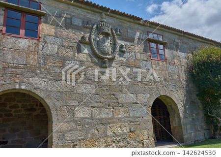 Nobility coat of arms and stone facade in the historic Pazo de Fefinans in Cambados de Pontevedra Nobility coat of arms and stone facade in the historic Pazo de Fefinans in Cambados de Pontevedra 142624530