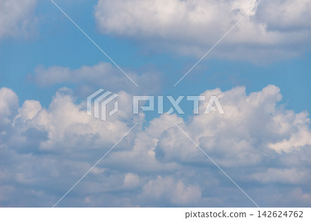 A view of fluffy, three-dimensional white clouds and blue sky, spread out in different stages above and below - from an upward-looking angle. A view of fluffy, three-dimensional white clouds and blue sky, spread out in different stages above and below - from an upward-looking angle. 142624762
