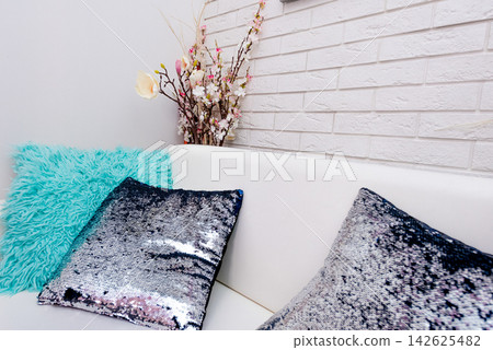 Colored soft pillows on sofa, cozy interior of hotel apartment living room Colored soft pillows on sofa, cozy interior of hotel apartment living room 142625482