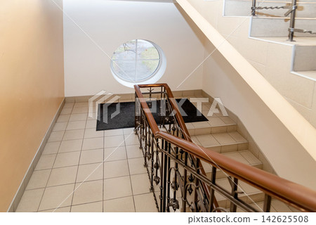 Staircase stair between floors, entrance to residential multi-storey building 142625508