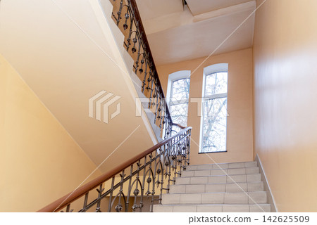 Staircase stair between floors, entrance to residential multi-storey building 142625509