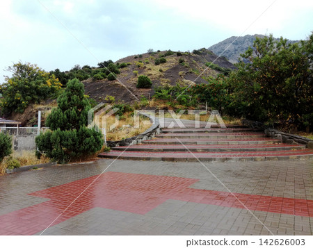 wide stone staircase leads up hill from paved plaza wide stone staircase leads up hill from paved plaza 142626003