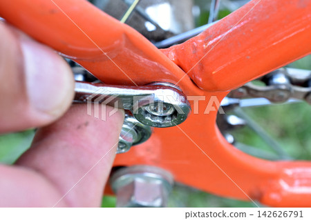 Bicycle repair with an open-end wrench. Bicycle repair with an open-end wrench. 142626791