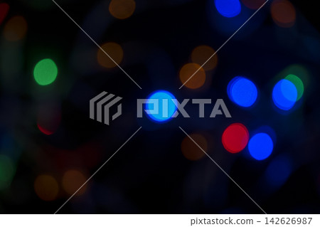 Colorful bokeh lights in blue, green, orange, and red on a dark background. Abstract festive texture. Abstract holiday illumination and decoration background Colorful bokeh lights in blue, green, orange, and red on a dark background. Abstract festive texture. Abstract holiday illumination and decoration background 142626987
