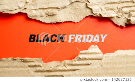 Black Friday text on a red background framed by torn corrugated cardboard. Great for holiday sale promotions. Concept of Black Friday 142627125