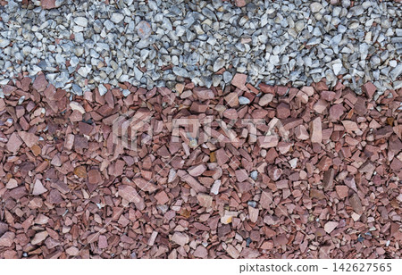 Abstract close-up texture of small crushed red and white stones arranged in contrasting horizontal bands. Suitable as background for landscaping, construction, geology, decorative aggregate concepts Abstract close-up texture of small crushed red and white stones arranged in contrasting horizontal bands. Suitable as background for landscaping, construction, geology, decorative aggregate concepts 142627565