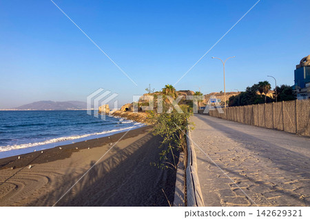 Golden sunrise light illuminates beach creating a peaceful Mediterranean seascape with gentle waves and rugged coastal scenery in Malaga, Spain Golden sunrise light illuminates beach creating a peaceful Mediterranean seascape with gentle waves and rugged coastal scenery in Malaga, Spain 142629321